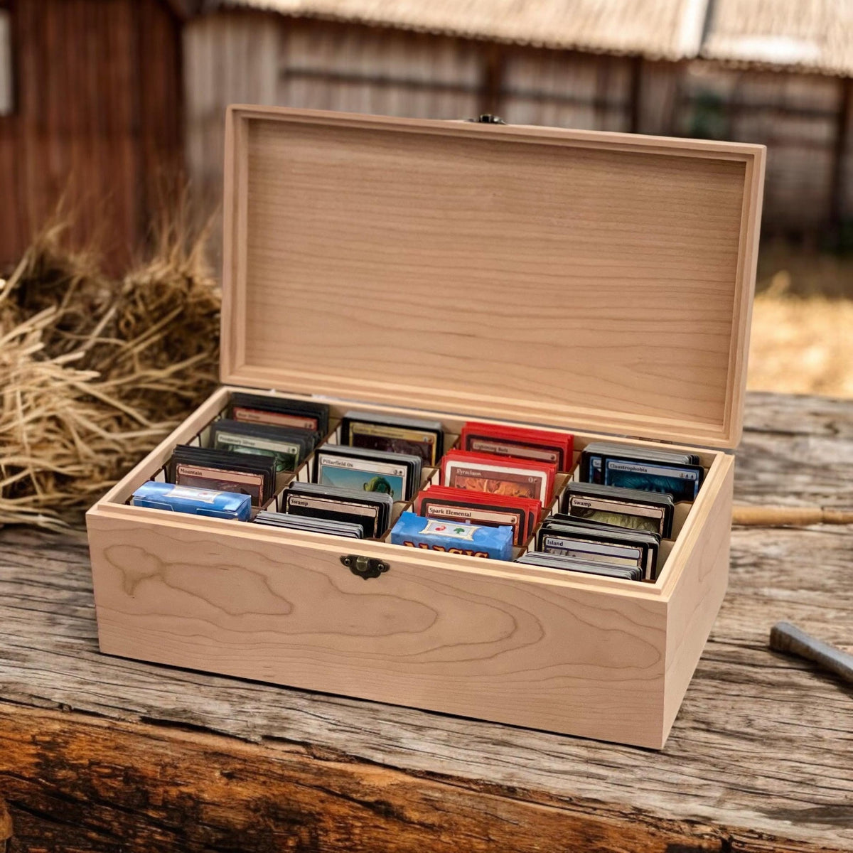 Maple slim 4-row wooden card storage box, 13⅜ x 7⅛ x 4¾ in, lid open and filled with sleeved trading cards, rustic setting, no engraving